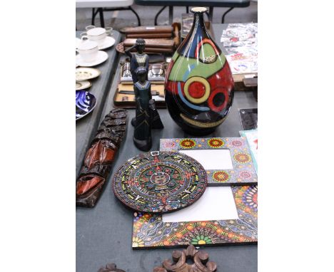 AN ETHNIC STYLE LOT TO INCLUDE PHOTO FRAMES, A LARGE COLOURFUL VASE, FIGURINES, A MASK AND AN AZTEC CALENDAR