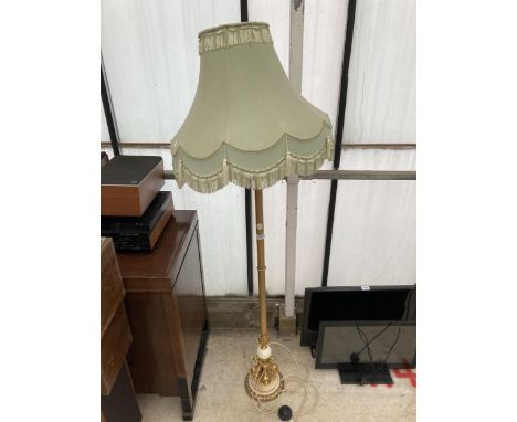 A DECORATIVE GILT STANDARD LAMP