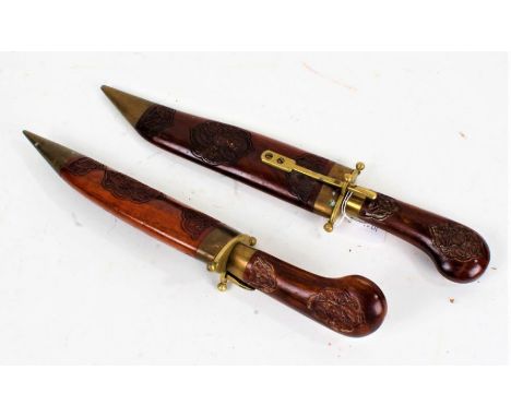 Middle Eastern knife and fork, housed in carved wooden and brass scabbards, the knife 34cm long including scabbard