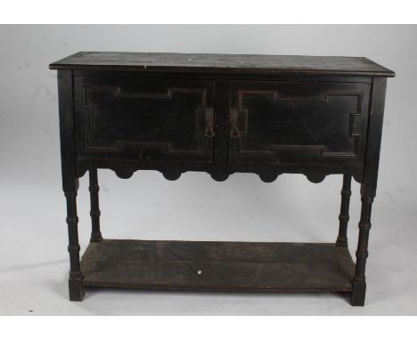 Jacobean style oak dresser base, having a pair of doors above a pot shelf, 122cm wide x 93.5cm high