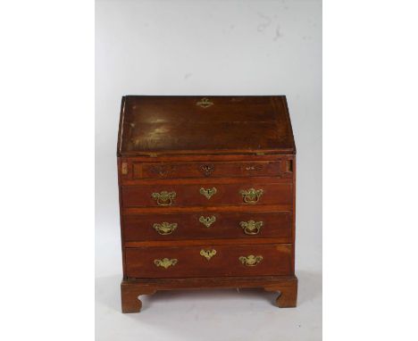 George III oak bureau, the crossbanded sloping fall enclosing a fitted interior, fitted four long graduating drawers, raised 