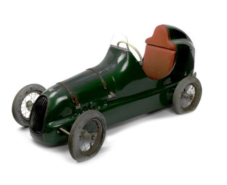 A 'Pathfinder' pedal car, later version,moulded fibreglass body work finished in Green, brown leather straps (split) to remov