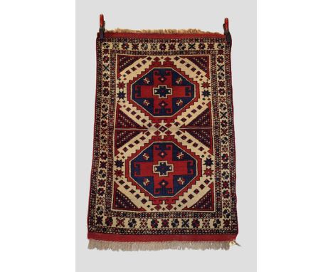 Bergama rug, west Anatolia, circa 1920s-30s, 3ft. 10in. X 2ft. 10in. 1.17m. X 0.86m. Two stepped octagonal medallions on an i