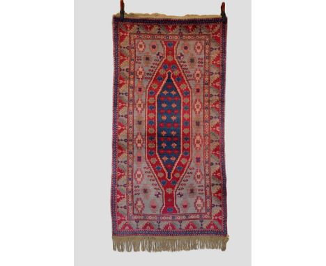 Two Samarkand rugs, Xinjiang, west China, mid-20th century, the first 5ft. 9in. X 3ft. 1.75m. X 0.91m. Central bright pink an
