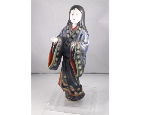 A Chinese figure of a robed woman decorated enamel colours (missing left hand) 24cm high 