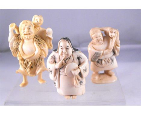 A late 19thC Japanese carved ivory netsuke, a man carrying a woman, another similar a man carrying a monkey and another a man