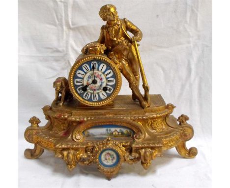 A Victorian mantle clock, the enamal dial painted with flowers and having Roman numerals in a gilt metal case surmounted with