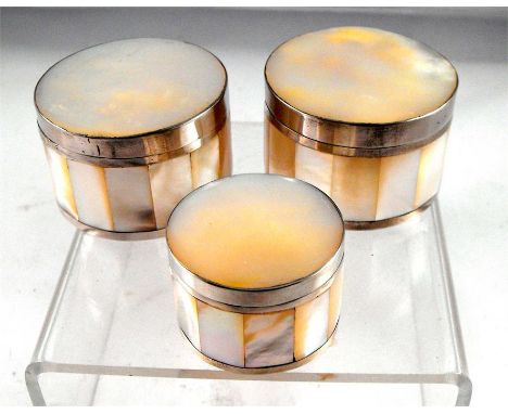 A pair of white metal and mother of pearl circular pots 5cm diameter and another smaller 4cm diameter (3) 