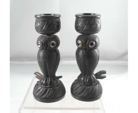 A pair of Victorian carved Irish bog oak candlesticks, in the form of owls, the sconces carved with shamrocks and a harp 10cm