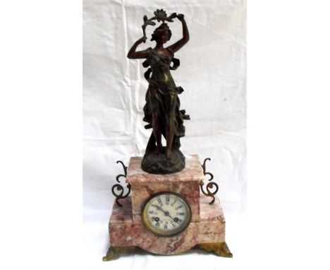 An Art Noveau mantle clock, the enamal dial with Roman and Arabic numerals in a rouge marble case surmounted a figure 51cm hi