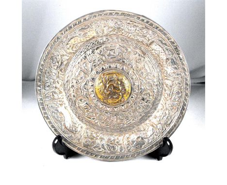 A 19thC Islamic silver dish decorated flowers with central brass boss 19cm diameter 