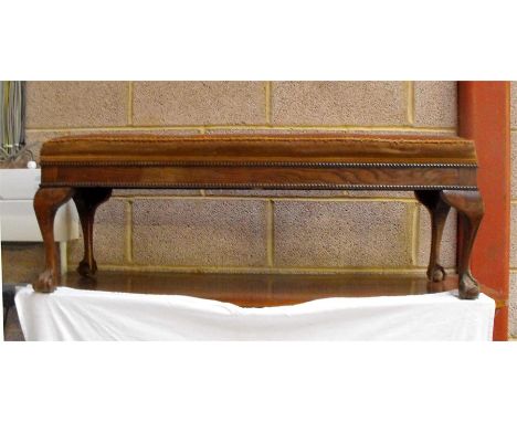 An oak stool with upholstered needlepoint seat on ball and claw feet 106cm wide 