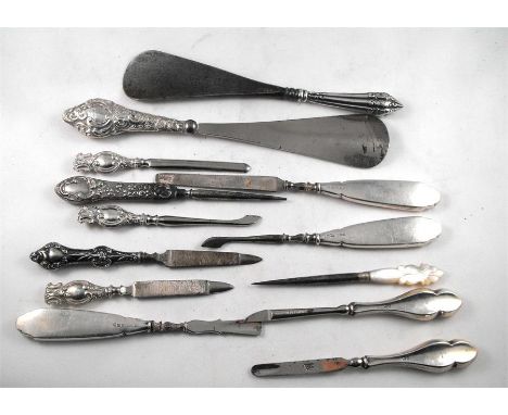 A group of silver handled manicure tools, and two silver handled shoe horns 