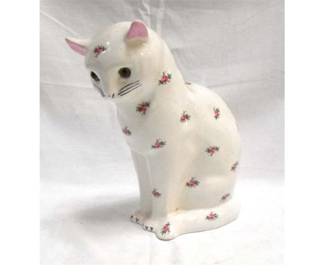 A large porcelain Plichta model of a seated cat with glass eyes, decorated flowers 26cm high 15