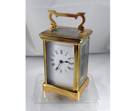 A Brass carriage time piece, the enamel dial having Roman Numerals 13cm high 