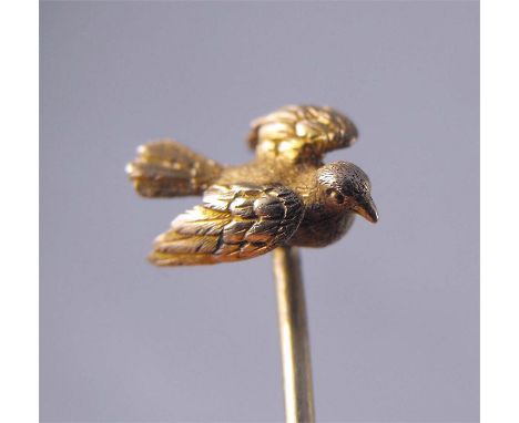 A Victorian yellow metal stick pin, modelled as a dove in flight 6cm high 