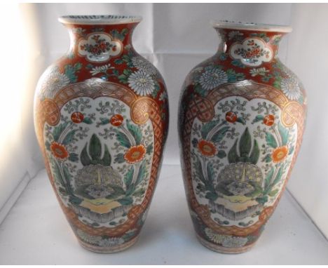 A pair of Japanese vases decorated enamel colours with a dragon and flowers with gilt highlights 25cm high 