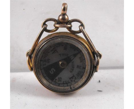 A Victorian gold plated compass fob with mother of pearl dial 2cm diameter 