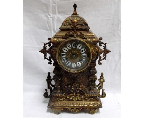 An ornate Victorian mantle clock with Roman Numerals in a brass case striking on a gong 23cm x 39cm 