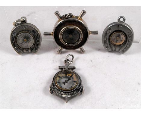 A Victorian Silver novelty fob compass in the form of a ships anchor, another similar in the form of ships wheel, and 2 more 