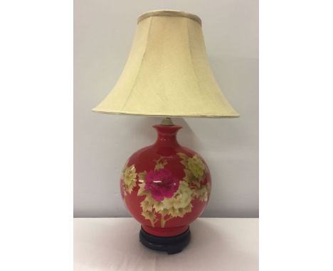 A large red ceramic oriental table lamp with fine marquetry decoration.Vendor advises perfect working order. Height including