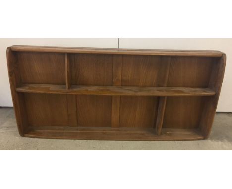 An Ercol wooden plate rack. 107cm x 50cm approx.