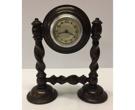 A c1930s mantle clock on barley twist support. In working order.