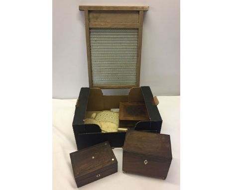 A box of misc items to include a vintage washboard and a tea caddy.