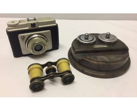 A German manufactured camera and a pair of French opera glasses together with a vintage plastic marble effect desk stand.
