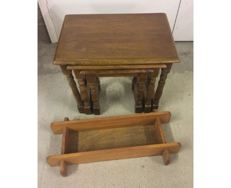 A light oak nest of 3 tables together with a small wooden shelf.