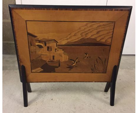 A vintage wooden firescreen with marquetry design to front.