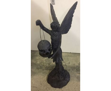 A large garden statue of an angel holding a metal tealight lamp. Made from resin. Approx 95cm high.