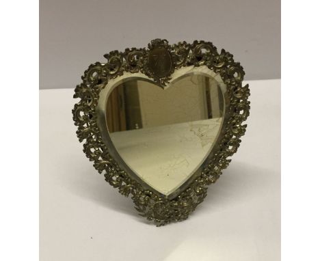 A vintage heart shaped white metal mirrors freestanding with 'Louie' engraved in cartouche. 19cm tall.