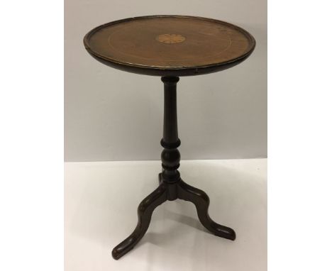 A tripod wine table with inlaid top.