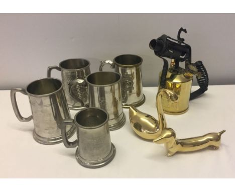 A box of mixed metalware to include pewter mugs and brass blow lamp.