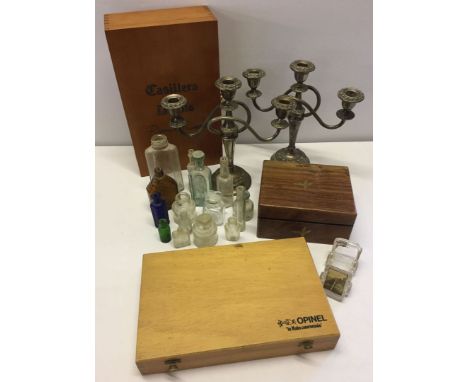 A mixed lot of misc items comprising wooden boxes vintage glass bottles and a pair of silver plated candleabras.