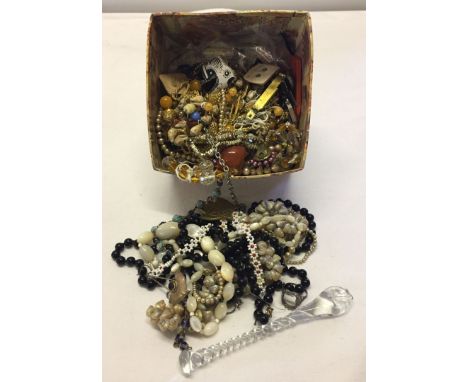 A square box of mostly vintage costume jewellery plus a glass sugar crusher.