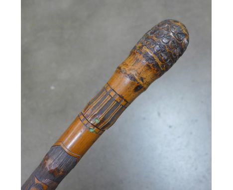 A bamboo swordstick carved with geisha girls 