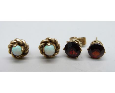 A pair of yellow metal and opal ear studs and a pair of yellow metal and garnet ear studs, total weight 3.6g, one lacking fas