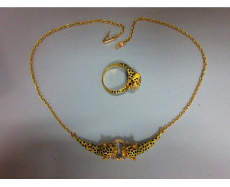 A gem set and enamel leopard necklace and ring suite, the leopard's heads all of textured yellow precious metal, with black e
