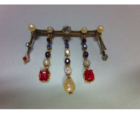 An early 20th century French diamond, ruby, sapphire and pearl brooch in 18ct gold, designed as a bar with a central 5-6mm ro