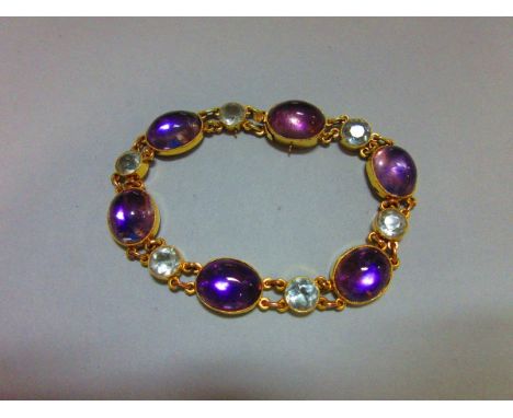 An aquamarine and amethyst bracelet, with six round cut and collet set aquamarines alternating with six larger oval cabochon 