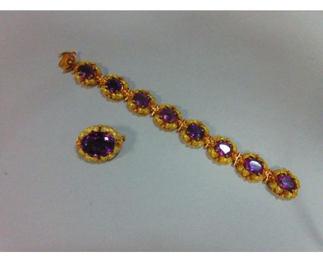An amethyst and bi-coloured bracelet and brooch suite, the bracelet with eight links each with an oval cut amethyst in a pier