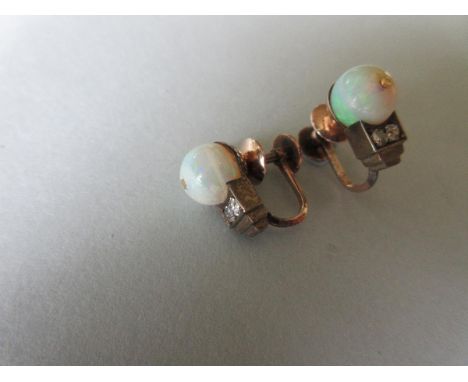 A pair of Art Deco opal and diamond screwback earrings, each designed as an opal bead set above two old round or cushion cut 