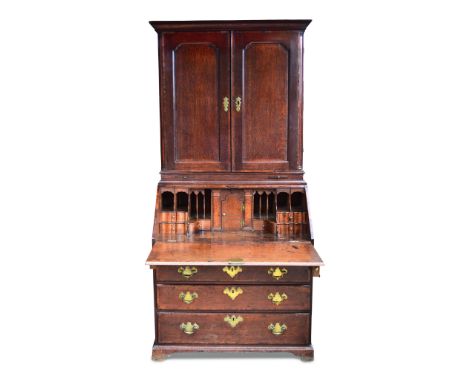 A George III oak bureau bookcase, panelled doors with quarter round columns, banded border decoration, candle slides, interna