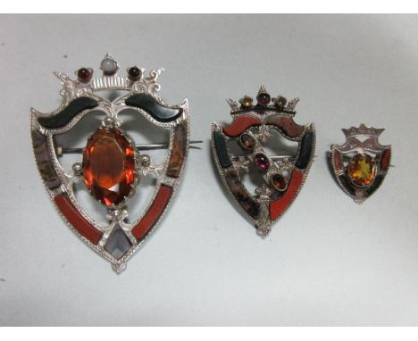 Three late Victorian Scottish agate and gem set luckenbooth brooches, each a pierced crowned shield set with different colour