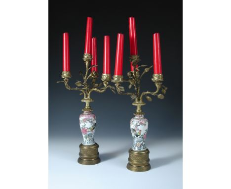 A pair of Samson chinoiserie porcelain and ormolu candelabra, the four-light gilt foliate arms with flower head sconces above