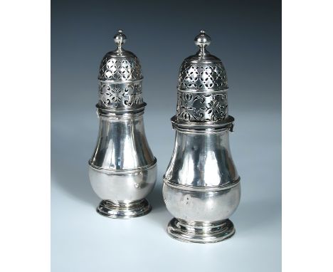 Two similar Queen Anne silver casters, by Charles Adam, London circa 1708, each of baluster form with moulded edges and girdl