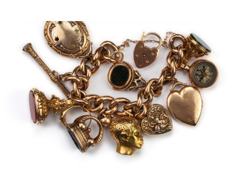 A charm bracelet with heart locket clasp and eleven pendant charms, the chunky curb link bracelet of rose precious metal susp