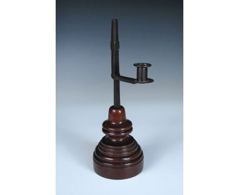 An 18th century wrought iron rush light, with turned yew wood base 31cm (12in) 